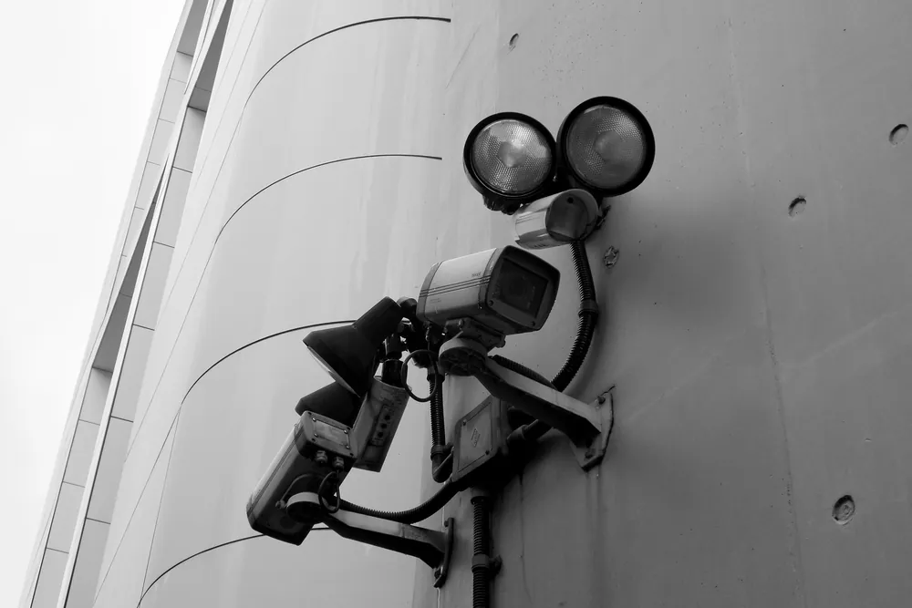 Security cameras with lights mounted on a wall
