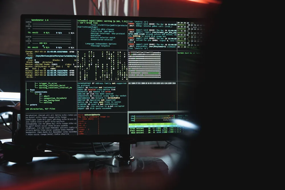 Computer monitor showing security code in a dark room