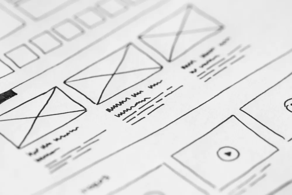 Hand-drawn website wireframe sketch on paper